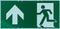 Sign with the pictogram of a walking person and an arrow in white on a green background, indication of an escape route in case of