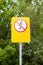 Sign prohibiting skiing. Against the background of green plants