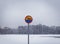 Sign prohibiting swimming on a frozen lake during a full winter snow