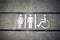 Sign of public toilets WC on wall outdoors. For female, male and disabled people