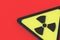 Sign of radiation hazard on red background