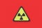 Sign of radiation hazard on red background