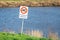 Sign reading `Forbidden to swim` near a river