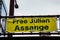 A sign reads FREE JULIAN ASSANGE