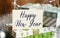 A sign that reads Happy New Year stands on the table with gift boxes in the background. Christmas background with decorations from