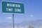 A sign that reads ï¿½Mountain Time Zoneï¿½