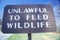 A sign that reads ï¿½Unlawful to feed wildlifeï¿½
