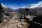 Sign on the rocky hill of punta union on the trekking of the quebrada santa cruz in peru, surrounded by high snowy mountains