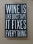 A sign with the saying â€œWine is like duct take it fixes everythingâ€.