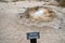 Sign for the Shell Spring, a bubbling hot spring geyser in Biscuit Basin, a thermal feature area of Yellowstone National Park