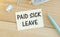 Sign showing hand written words Paid family leave