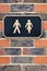 Sign Showing Male And Female Figures Outside Public Toilet To Illustrate Gender Issues