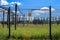 Sign showing the words high voltage in german language at the fence of a big substation distributing electric energy with lots