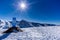 Sign on ski slopes with directions to villages. Beautiful mountain range covered in snow