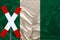 Sign, stop, attention on the background of the silk national flag of the country of Nigeria, the concept of border and customs