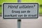 Sign on the street asking to let the dog out on the other side of the street in Nieuwerkerk aan den IJssel in the Netherlands.