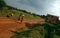 A sign beside a stretch of dirt road, Gulu, Uganda.