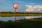 Sign `swimming is forbidden` on the bank of the academic rowing channel