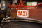 Sign Taxi vintage old background on the red