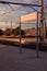 Sign at the train station during the morning, train tracks. Empty sign with space to write