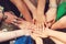 Sign of trustful friendship. Top view group of children stacking hands outdoors