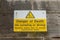 A sign on a wall near the sea warning of the dangers of jumping in the sea and that there is a danger of death