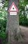 Sign warning Achtung Zecken on a tree trunk in the forest