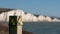 Sign warning of the danger of erosion at the cliff edge overlooking Seven Sisters at Seaford in East Sussex, south coast of UK