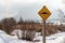 Sign warning drivers of a speed bump ahead. Photo taken in Banff National Park during winter while snow was falling