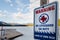 Sign warning that there is no lifeguard on duty at near a frozen winter lake.