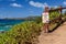 Sign Warning Unstable Cliff Stay Back on Maui Overlooking Blue Water With Blue Sky