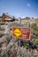 Sign warning visitors to Bodie State Historic Park in California to keep out of unstable structures and grounds