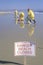 A sign warning ï¿½Dangerï¿½ after an oil spill closed Huntington Beach, as cleanup workers remove oil from the California