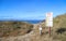 A sign warns of cliffside hazards at Davenport Pier