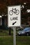 Sign on well traveled road changing one lane into bicycle lane
