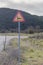 Sign `Wild Animals` on a rural road