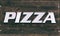 Sign on wooden table pizza