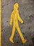 Sign of a yellow person walking on the floor in a parkinglot