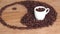 A sign of yin and yang from coffee beans. The yin and yang sign is laid out on the kitchen marble table. In the sign is a white cu