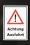Signage attention with exclamation mark Achtung Ausfahrt  - attention exit - at a gate in Germany