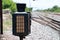 Signal lamp shunting railroad tracks beside the railway