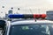 signal lights on police car against the backdrop of cityscape. Blue and red flashing lights on roof of police car.