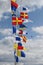 Signal marine multi colored flags fluttering on flagpoles adorn the sea pier.