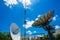 Signal Tower and Sky satellite dish are large and the clouds are white as a backdrop, high telecommunication signal, wireless