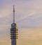 Signal transmitting tower with a colorful sky full of clouds, telecommunication technology and architecture