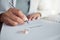 Signature, ring and divorce paper of a woman at table with legal paperwork, anxiety or documents. Female person sign