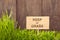 Signboard on keep of Grass background of wood planks,