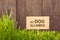 Signboard no dog allowed on Grass background of wood planks,