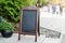 Signboard on the street. Empty menu board stand. Restaurant sidewalk chalkboard sign board. Freestanding A-frame blackboard near