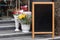 Signboard on the street. Empty menu board stand. Restaurant sidewalk chalkboard sign board. Freestanding A-frame blackboard near